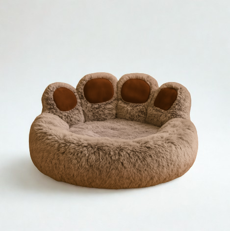 Brown paw-shaped pet bed on a white background